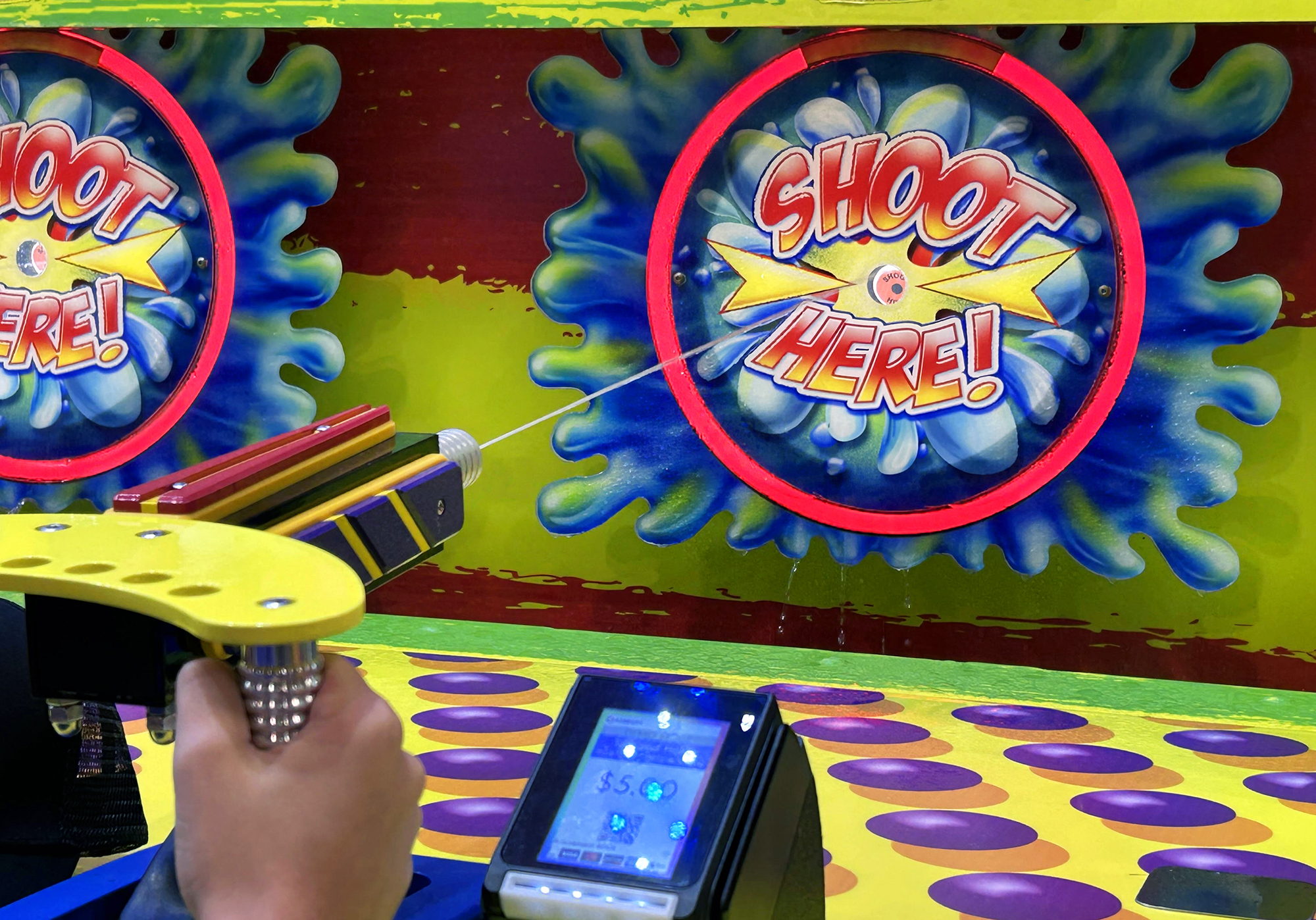 Some traditional midway rides can be found on the exhibit floor, like this water gun skill challenge.